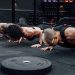 Group workout session in a Mexico City gym with athletes doing push-ups.